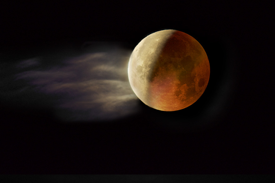 Partially eclipsed moon and cloud.
